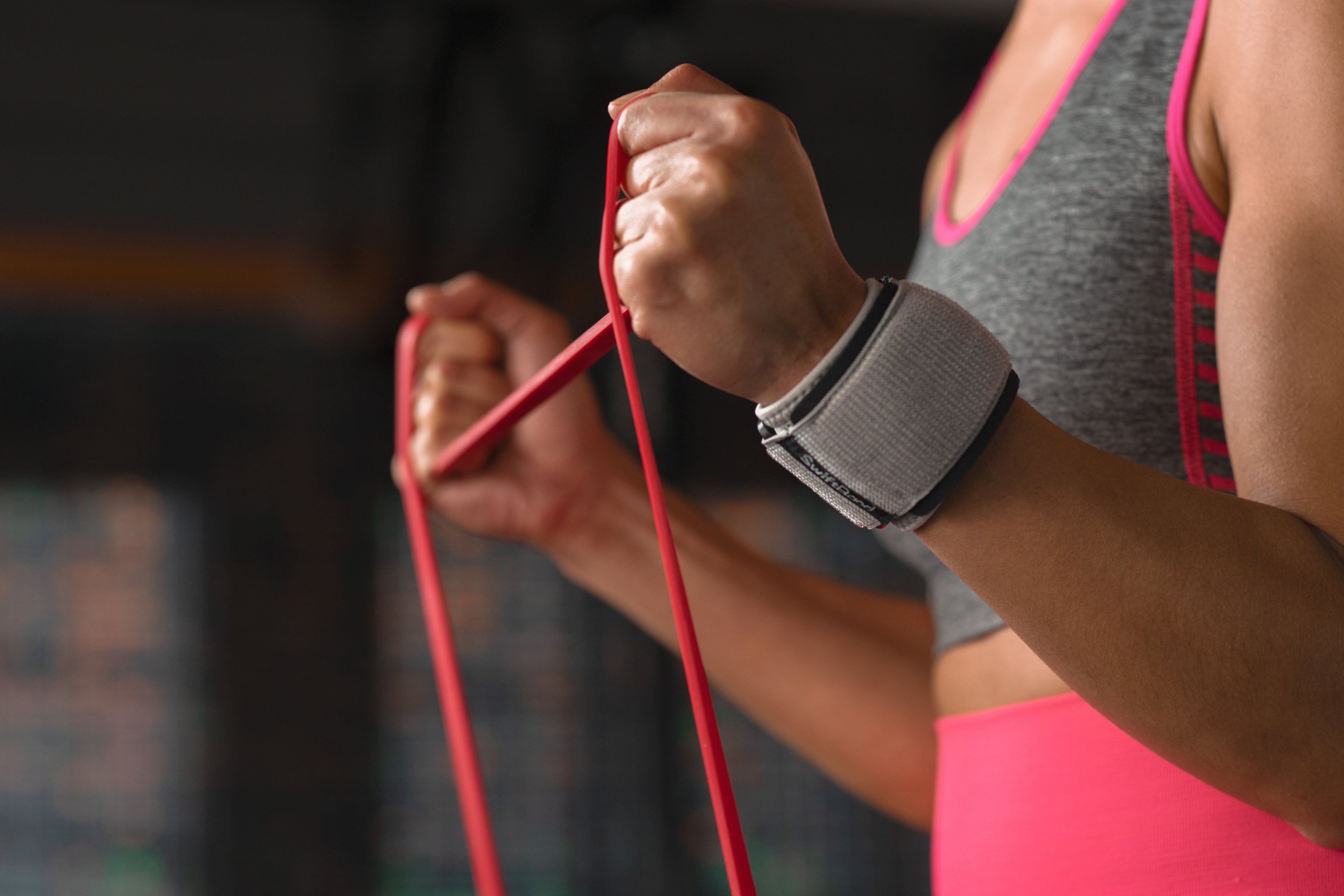 Person exercising with a resistance band in a gym setting