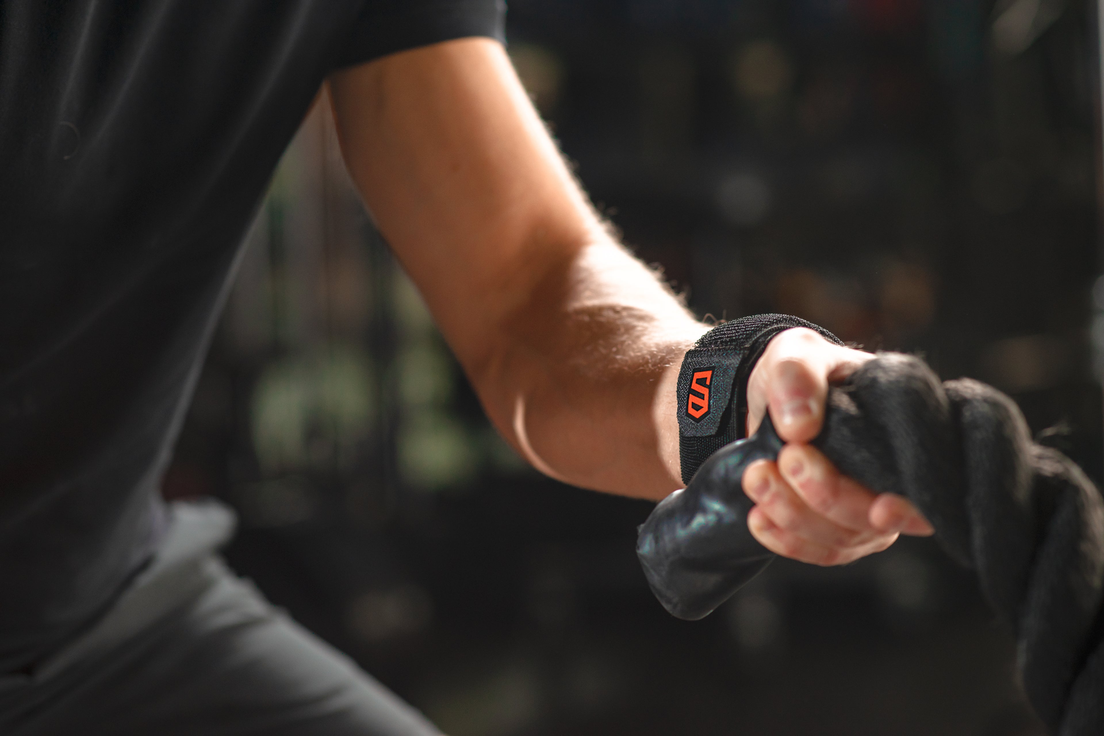 Person holding hands with another person against a blurred natural background